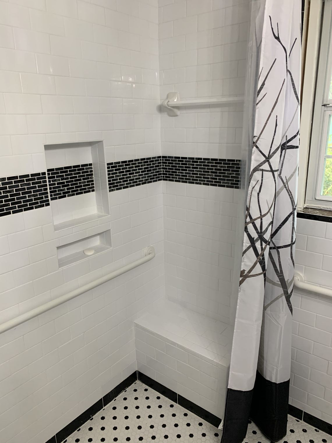 Shower with grab bars and bench