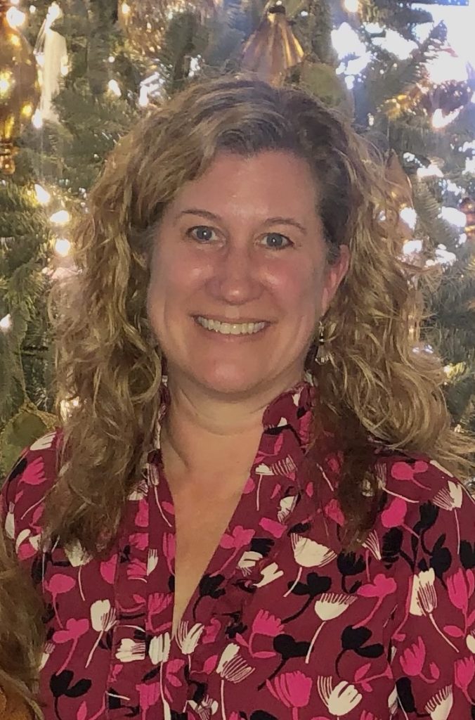 woman personal headshot in front of Christmas tree