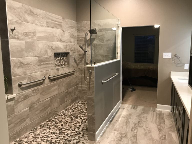 Wheelchair accessible shower remodel with silver grab bars