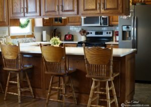 Country style wood kitchen with island and chairs