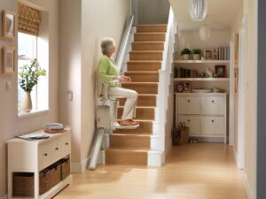 Woman uses stairlift to go upstairs